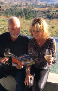 couple on a wine tour reading The BC Wine Tour Handbook