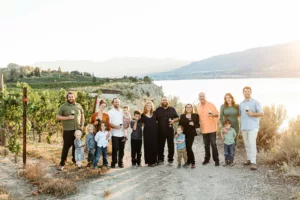 The Hollers family photo withe vineyard and lake view from Poplar Grove Winery