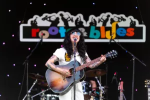 singer performing at roots and blues music festival