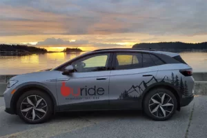 uride SUV overlooking lake at sunset