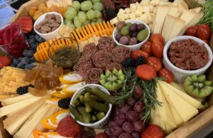 charcuterie board selection of cheese, meat, olives, fruit